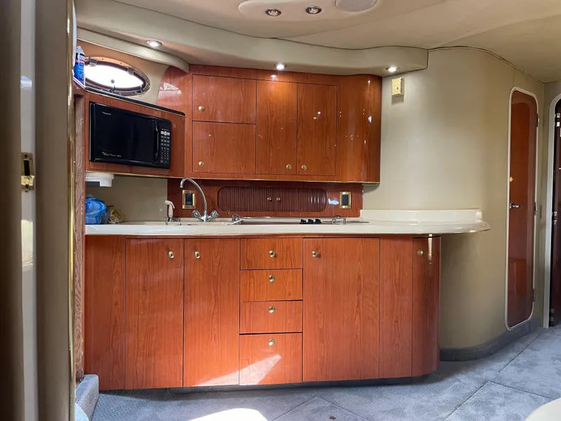 Slide: The Image of 1998 Sea Ray 400 Sundancer yacht kitchen with wood cabinets and modern appliances. - 5