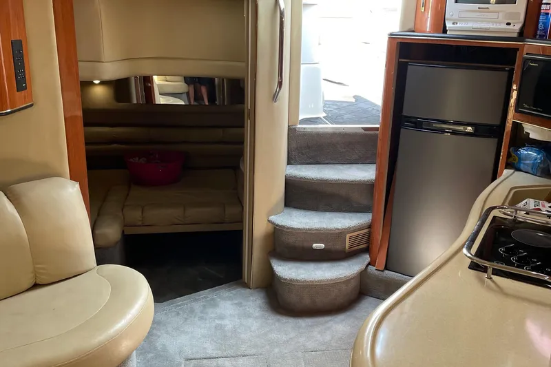 Slide: The Image of Interior of 1998 Sea Ray 400 Sundancer yacht with kitchen and seating area. - 6