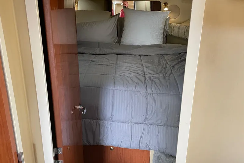 Slide: The Image of Cozy bedroom interior of 1998 Sea Ray 400 Sundancer yacht with gray bedding. - 8