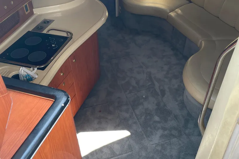Slide: The Image of Interior of 1998 Sea Ray 400 Sundancer with kitchen and seating area. - 9