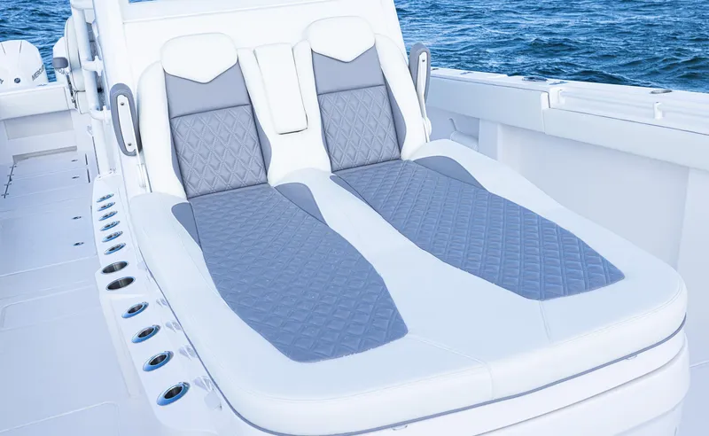 Slide: The Image of 2025 Invincible 35 Catamaran with luxurious seating, ocean backdrop. - 12