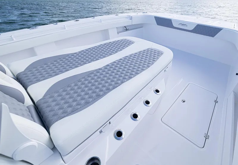 Slide: The Image of 2025 Invincible 35 Catamaran with cushioned seating and ocean view. - 15