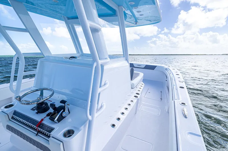 Slide: The Image of 2025 Invincible 35 Catamaran on open water, showcasing sleek design and spacious deck. - 16