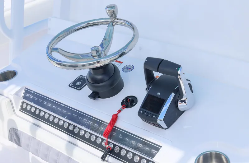 Slide: The Image of 2025 Invincible 35 Catamaran helm with steering wheel and controls. - 19