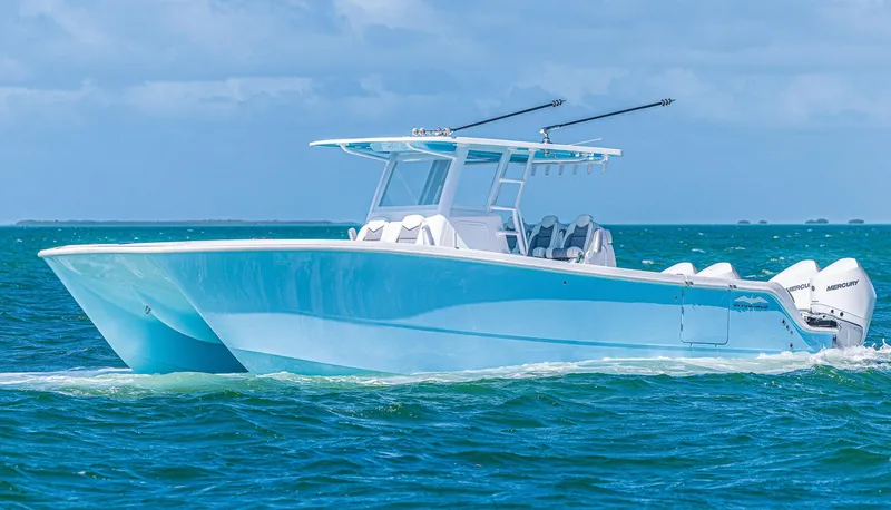 Slide: The Image of 2025 Invincible 35 Catamaran cruising on blue ocean waters. - 2