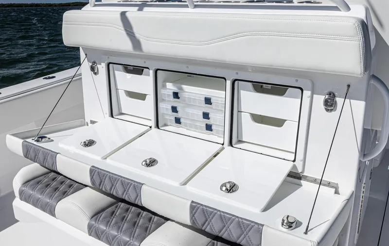 Slide: The Image of 2025 Invincible 35 Catamaran interior with storage compartments and cushioned seating. - 22
