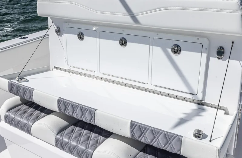 Slide: The Image of 2025 Invincible 35 Catamaran seating with storage compartments, quilted cushions, and sleek design. - 23