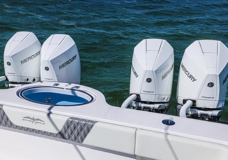 Slide: The Image of 2025 Invincible 35 Catamaran with four Mercury outboard engines on the ocean. - 26