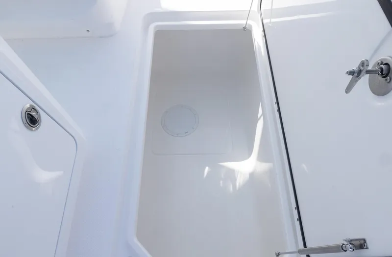 Slide: The Image of Invincible 35 Catamaran 2025 interior storage compartment, white finish, open hatch. - 29