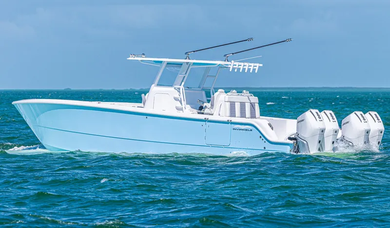 Slide: The Image of 2025 Invincible 35 Catamaran cruising on open water with triple outboard engines. - 3