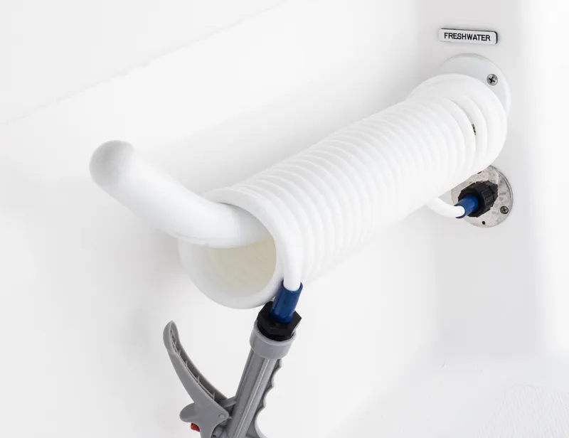 Slide: The Image of Freshwater hose on 2025 Invincible 35 Catamaran, neatly coiled for storage. - 32