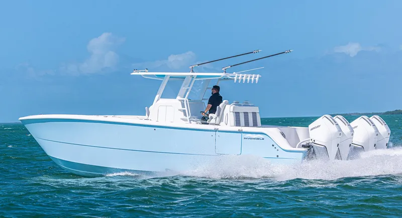 Slide: The Image of 2025 Invincible 35 Catamaran cruising on open water, showcasing sleek design and powerful engines. - 37
