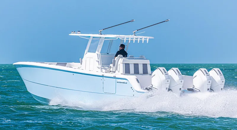 Slide: The Image of 2025 Invincible 35 Catamaran speeding on ocean with triple outboard engines. - 38