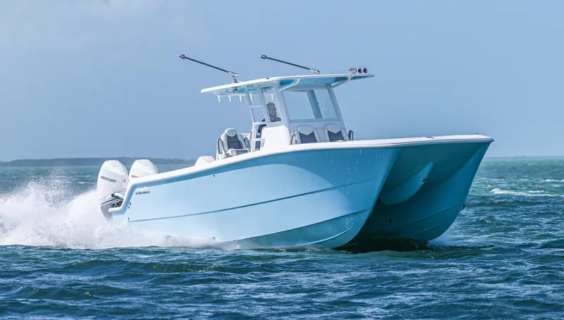Slide: The Image of 2025 Invincible 35 Catamaran cruising on open water. - 6