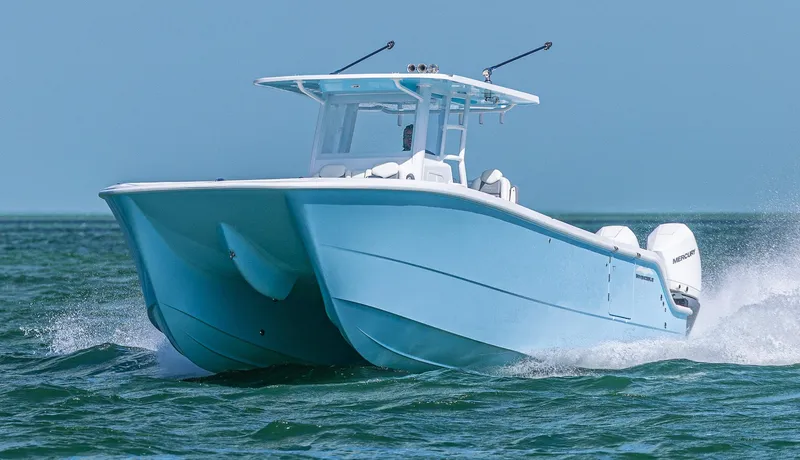 Slide: The Image of 2025 Invincible 35 Catamaran cruising on open water, showcasing sleek design and performance. - 7