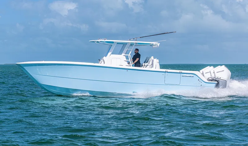 Slide: The Image of 2025 Invincible 35 Catamaran cruising on open water under clear skies. - 8