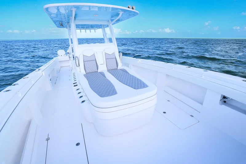 Slide: The Image of Invincible 35 Catamaran 2025 on open sea, featuring spacious deck and seating. - 9
