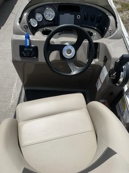 Slide: The Image of 2023 Sun Tracker Party Barge 18 steering console with gauges and controls. - 4