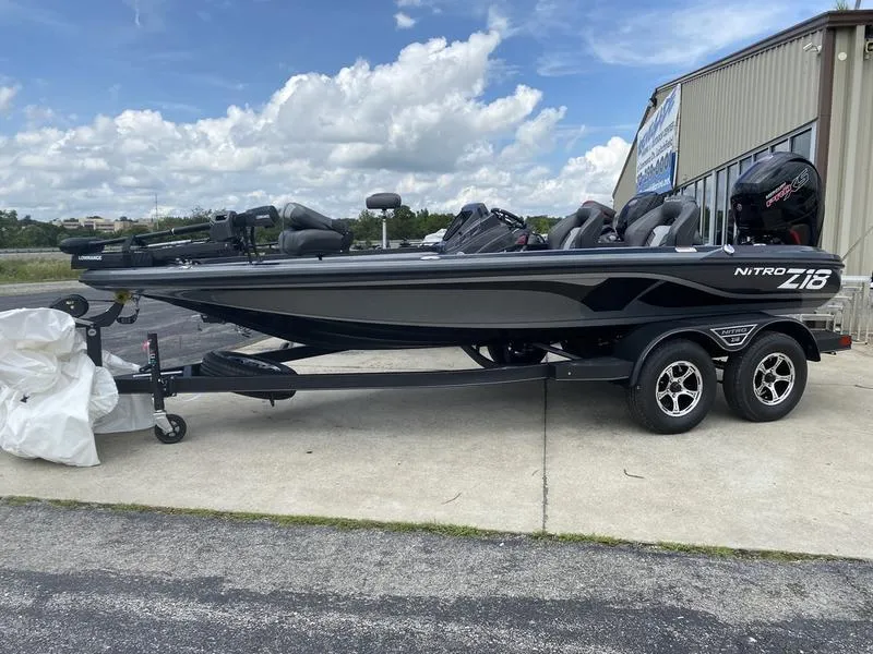 The Image of 2022 Nitro Z18 boat on trailer, parked outdoors under a cloudy sky. - 1