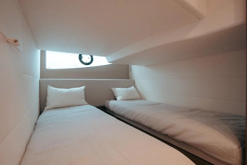 Slide: The Image of Twin beds in a 2021 Princess V40 yacht cabin, featuring modern design and comfort. - 13