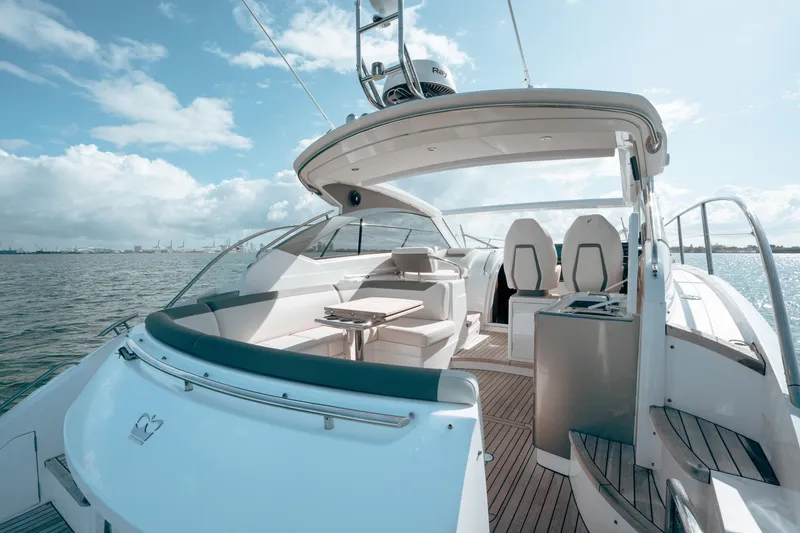 Slide: The Image of Luxurious 2021 Princess V40 yacht with spacious deck and seating, cruising on open water. - 16