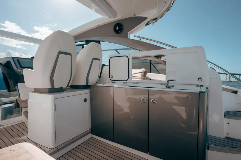 Slide: The Image of Luxury yacht interior with sleek design, featuring modern seating and cabinetry, Princess V40 2021 model. - 19
