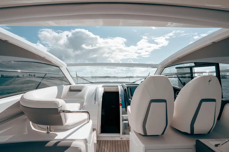 Slide: The Image of Interior view of 2021 Princess V40 yacht, featuring sleek seating and expansive ocean view. - 22