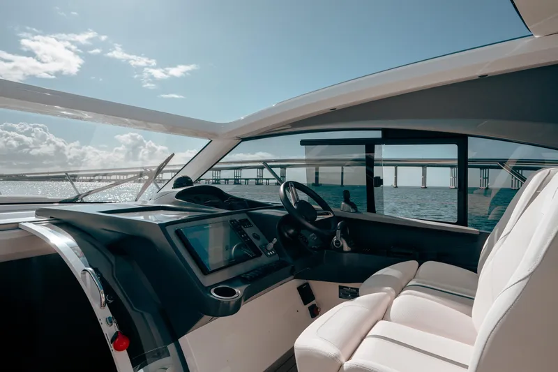 Slide: The Image of Interior of 2021 Princess V40 yacht with modern dashboard and ocean view. - 23
