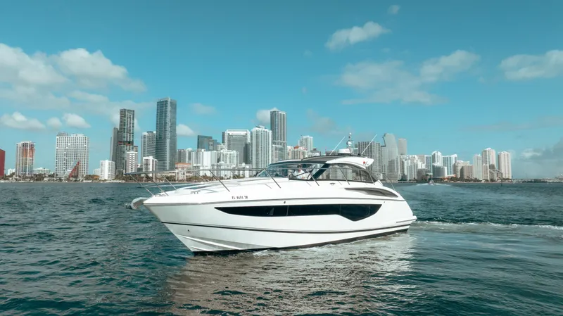 Slide: The Image of 2021 Princess V40 yacht cruising near city skyline under blue sky. - 6