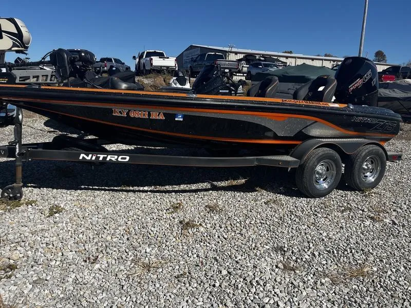 Slide: The Image of 2019 Nitro Z18 boat on trailer, parked on gravel lot. - 1