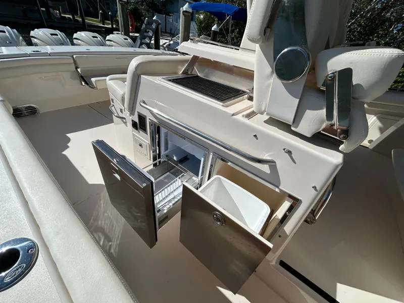 Slide: The Image of 2024 Grady-White Canyon 456 boat interior with open storage compartments. - 10