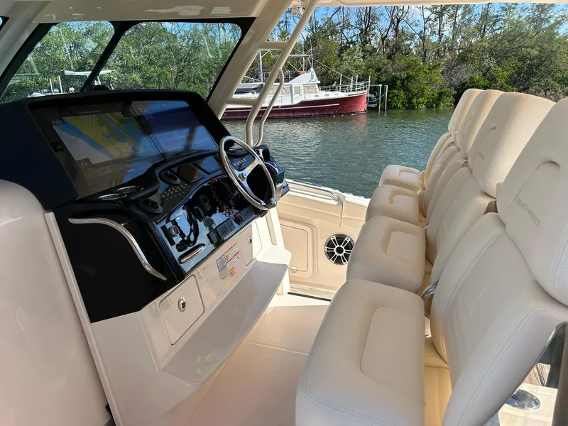 Slide: The Image of 2024 Grady-White Canyon 456 boat interior with helm and seating. - 12