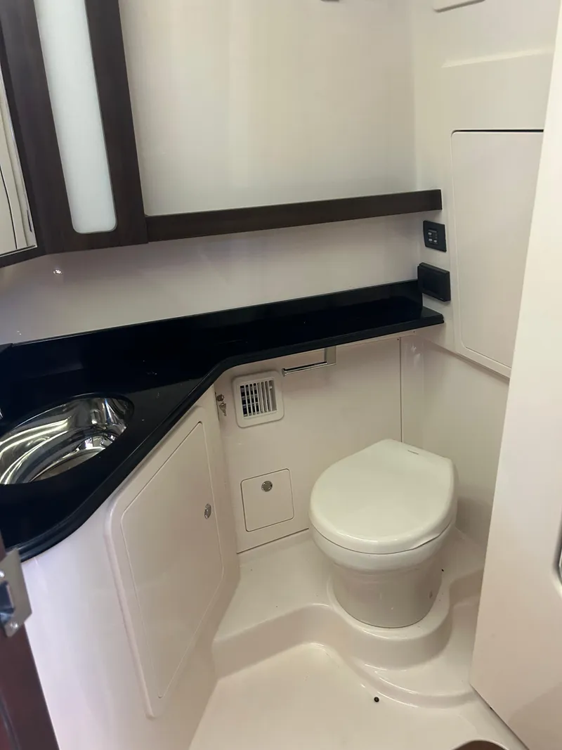Slide: The Image of 2024 Grady-White Canyon 456 boat bathroom with modern fixtures and sleek design. - 13