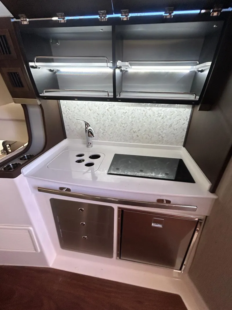Slide: The Image of 2024 Grady-White Canyon 456 boat kitchen with modern appliances and sleek design. - 15