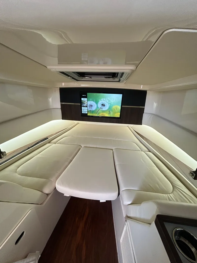 Slide: The Image of Luxurious interior of 2024 Grady-White Canyon 456 boat with TV and plush seating. - 17