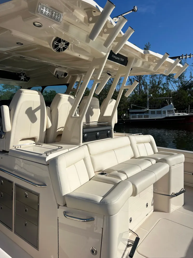 Slide: The Image of 2024 Grady-White Canyon 456 boat interior with luxurious seating and rod holders. - 20