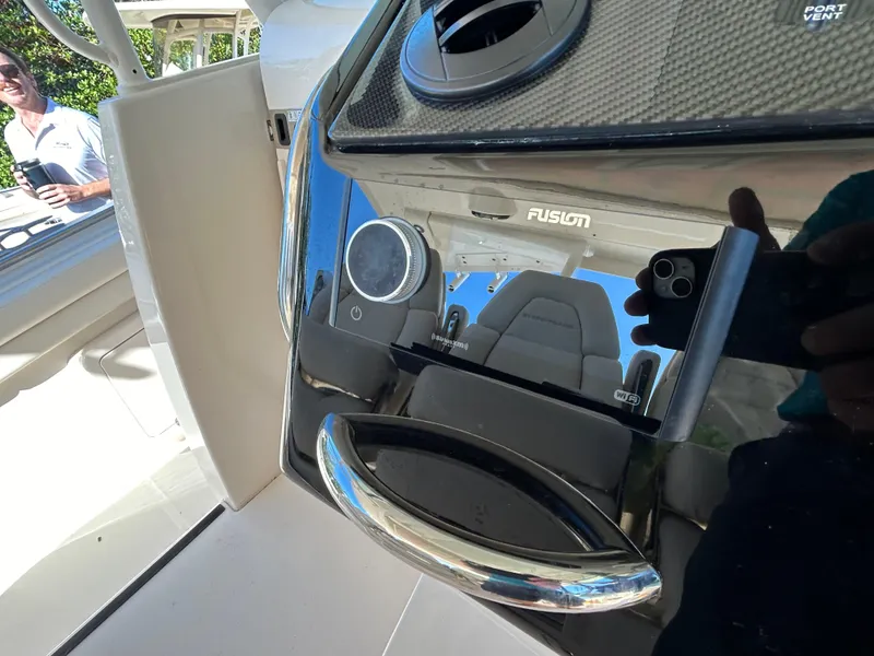 Slide: The Image of 2024 Grady-White Canyon 456 boat interior with Fusion audio system and seating. - 5