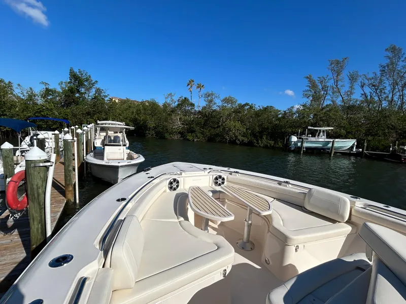 Slide: The Image of 2024 Grady-White Canyon 456 boat docked in a scenic marina. - 6