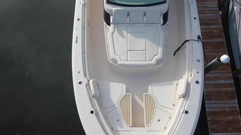 Slide: The Image of 2024 Grady-White Canyon 456 boat docked, aerial view of bow seating area. - 8