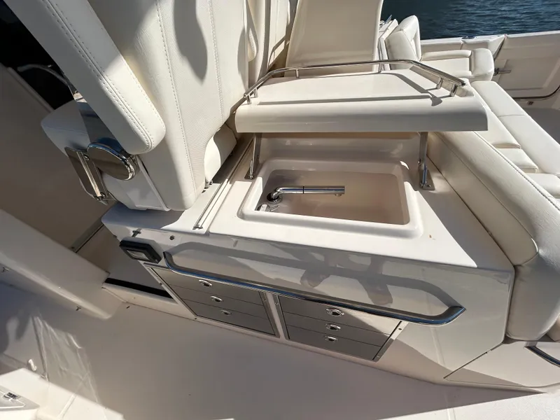 Slide: The Image of 2024 Grady-White Canyon 456 boat interior with sink and storage drawers. - 9