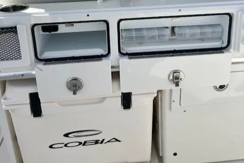 Slide: The Image of 2025 Cobia 265 Center Console Open storage compartments and cooler. - 14
