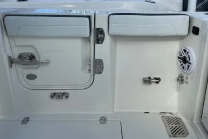 Slide: The Image of 2025 Cobia 265 Center Console Open boat interior with storage compartments and speaker. - 16