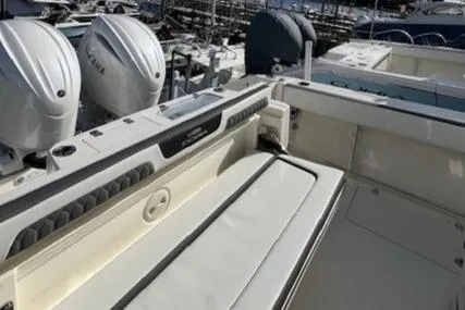 Slide: The Image of 2025 Cobia 265 Center Console Open boat with Yamaha engines, docked at marina. - 17