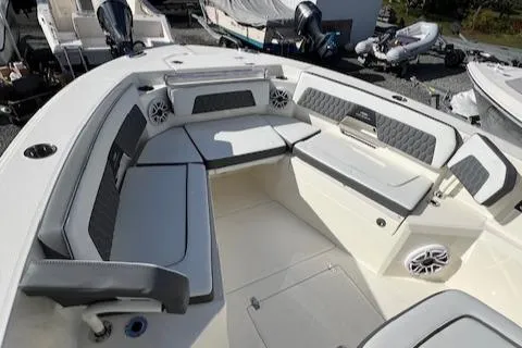 Slide: The Image of 2025 Cobia 265 Center Console Open boat interior with cushioned seating and speakers. - 30