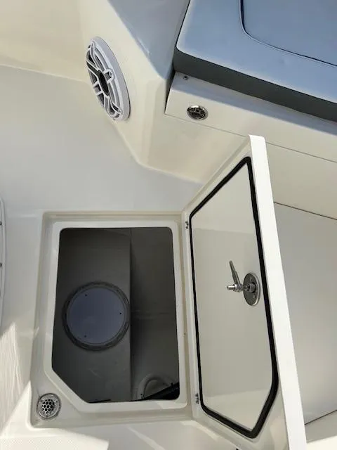 Slide: The Image of 2025 Cobia 265 Center Console Open storage compartment with open hatch. - 35
