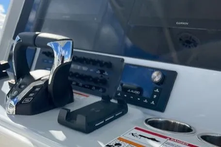 Slide: The Image of 2025 Cobia 265 Center Console Open dashboard with controls and navigation equipment. - 37
