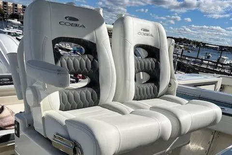 Slide: The Image of Luxury seating on 2025 Cobia 265 Center Console Open boat, dockside view. - 38