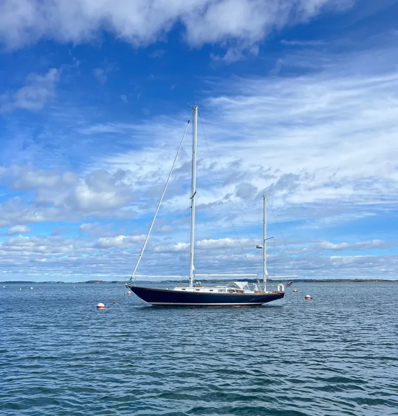 Slide: The Image of 1967 Hinckley Bermuda sailboat on calm sea under blue sky. - 2