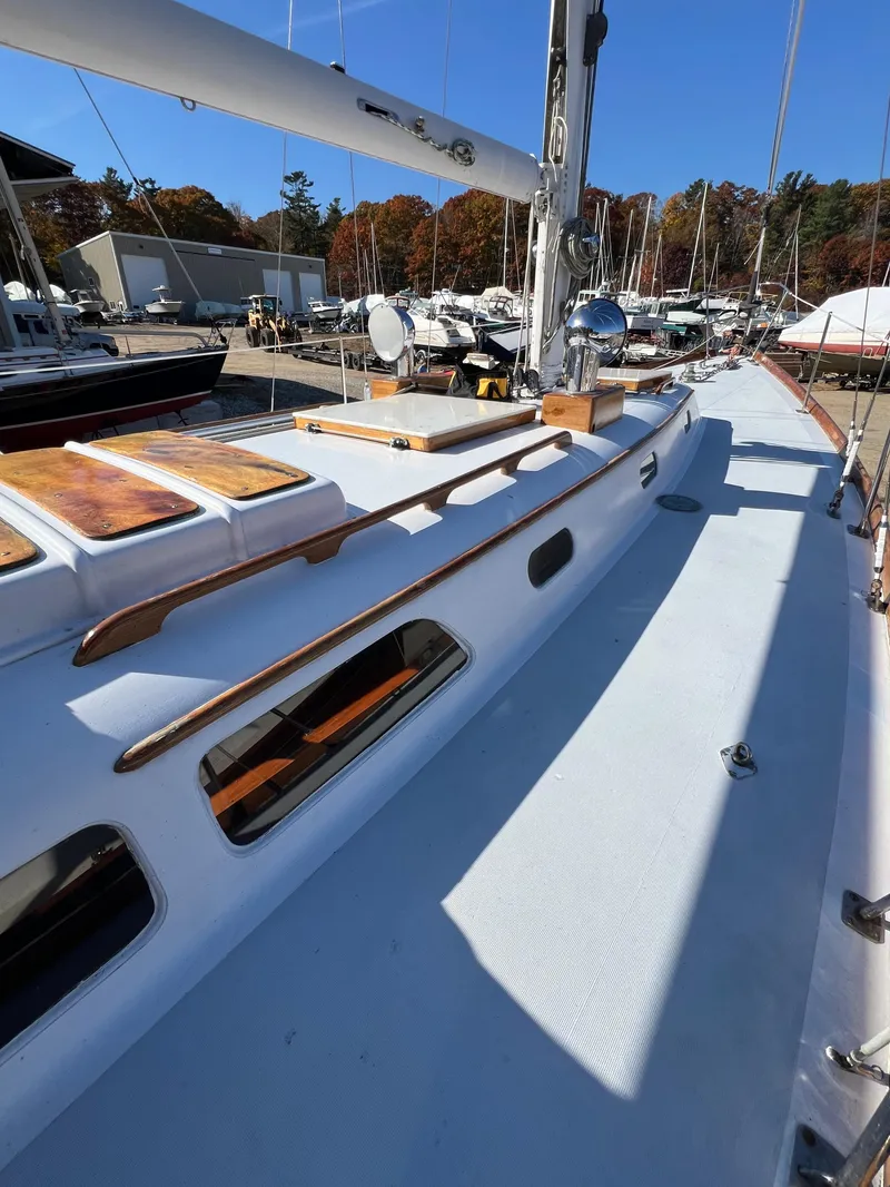 Slide: The Image of 1967 Hinckley Bermuda sailboat deck with wooden accents and clear blue sky. - 20