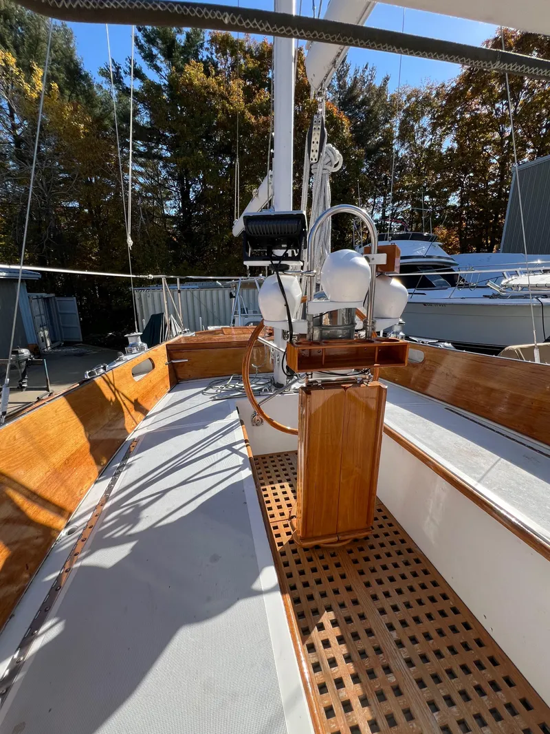 Slide: The Image of 1967 Hinckley Bermuda sailboat deck with wooden accents and steering wheel. - 22